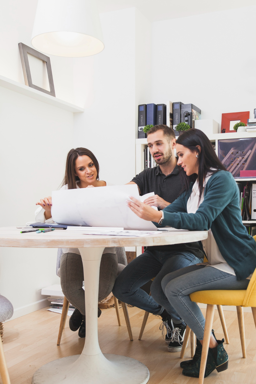 coworkers sitting with blueprint